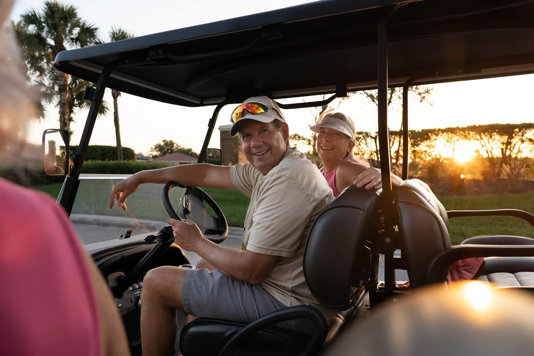 Couple cruising the community in a golf cart