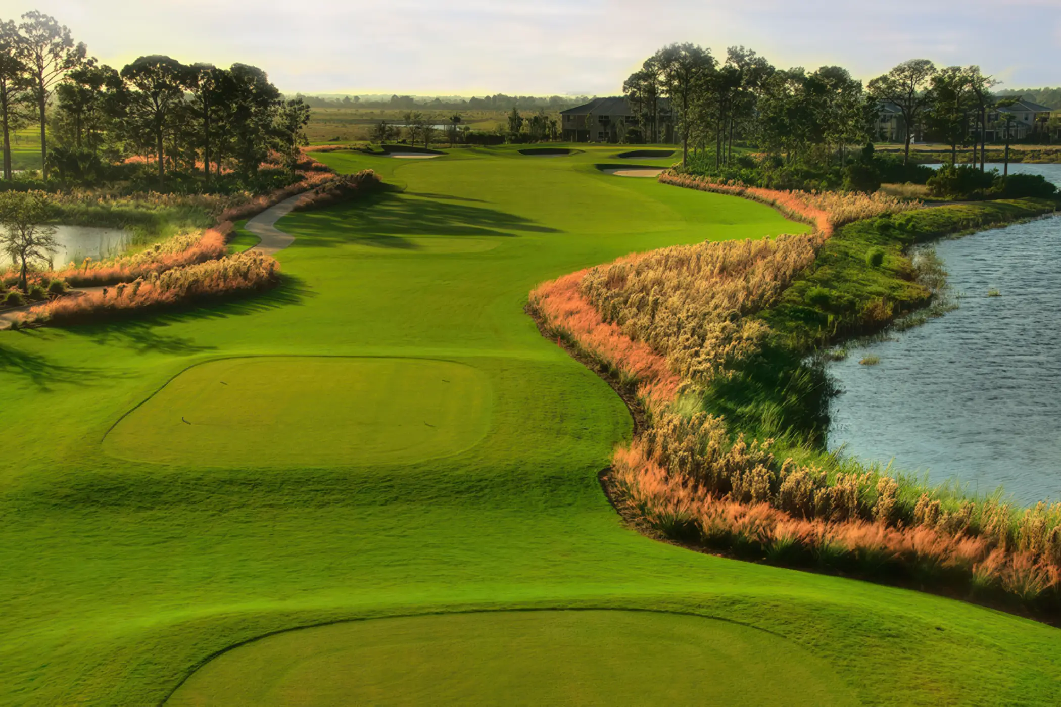 Golf tee box beside a sparkling lake on the championship course