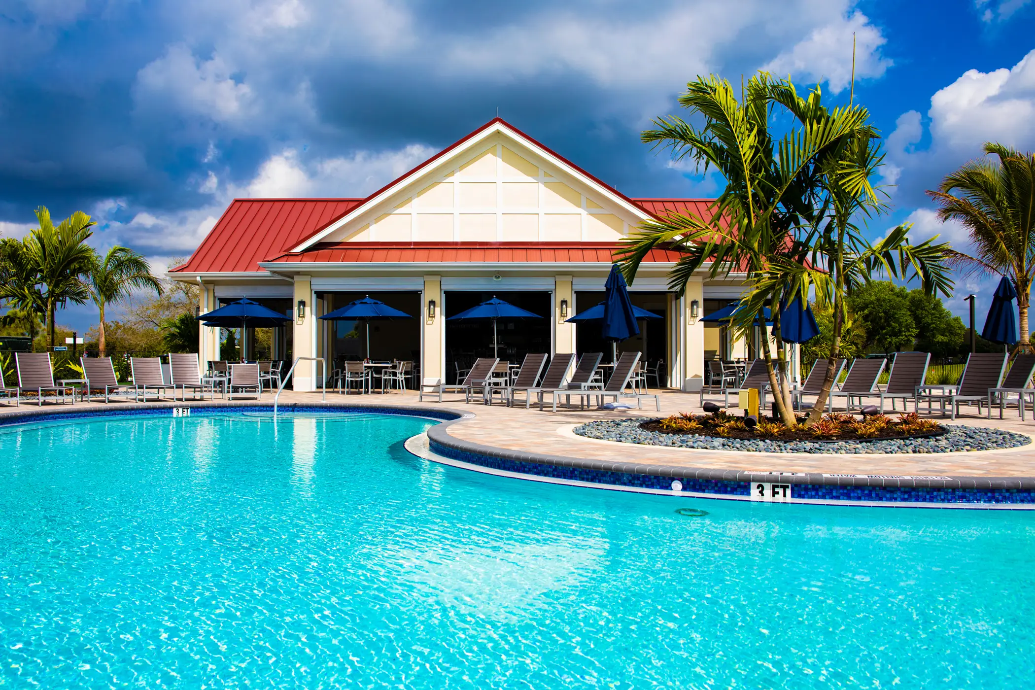 Resort-style swimming pool with lounge chairs at River Hall in Alva FL